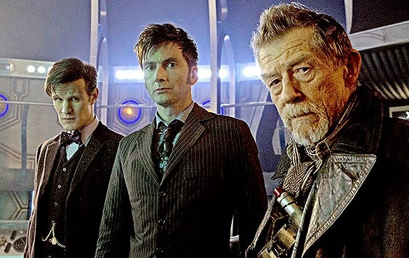 This image from "Day of the Doctor" (Doctor Who's Fiftieth Anniversary Special episode) shows, from left to right, the Eleventh Doctor (played by Matt Smith), the Tenth Doctor (played by David Tennant), and the War Doctor (played by John Hurt) standing in the Control Room of Eleven's TARDIS. All three Doctors look directly into the camera's lens. This image from "Day of the Doctor" (Doctor Who's Fiftieth Anniversary Special episode) shows, from left to right, the Eleventh Doctor (played by Matt Smith), the Tenth Doctor (played by David Tennant), and the War Doctor (played by John Hurt) standing in the Control Room of Eleven's TARDIS. All three Doctors look directly into the camera's lens.