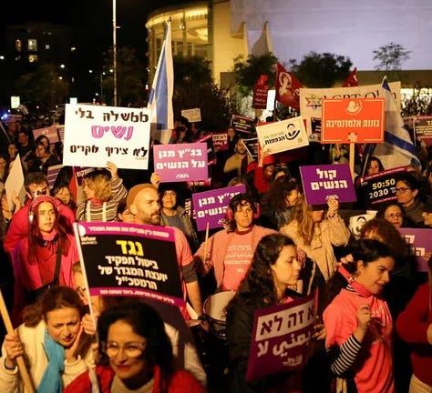 Some of the crowd at Sunday’s protest to protect women in Tel Aviv. Signs read, “A govt without women is not a coincidence”, “Against cancelling the position of gender consultant of the army director general”,  and "The high court protects women”