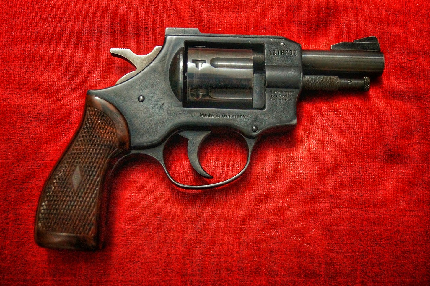 Picture of a short barrel .38 revolver, black frame, brown grip.