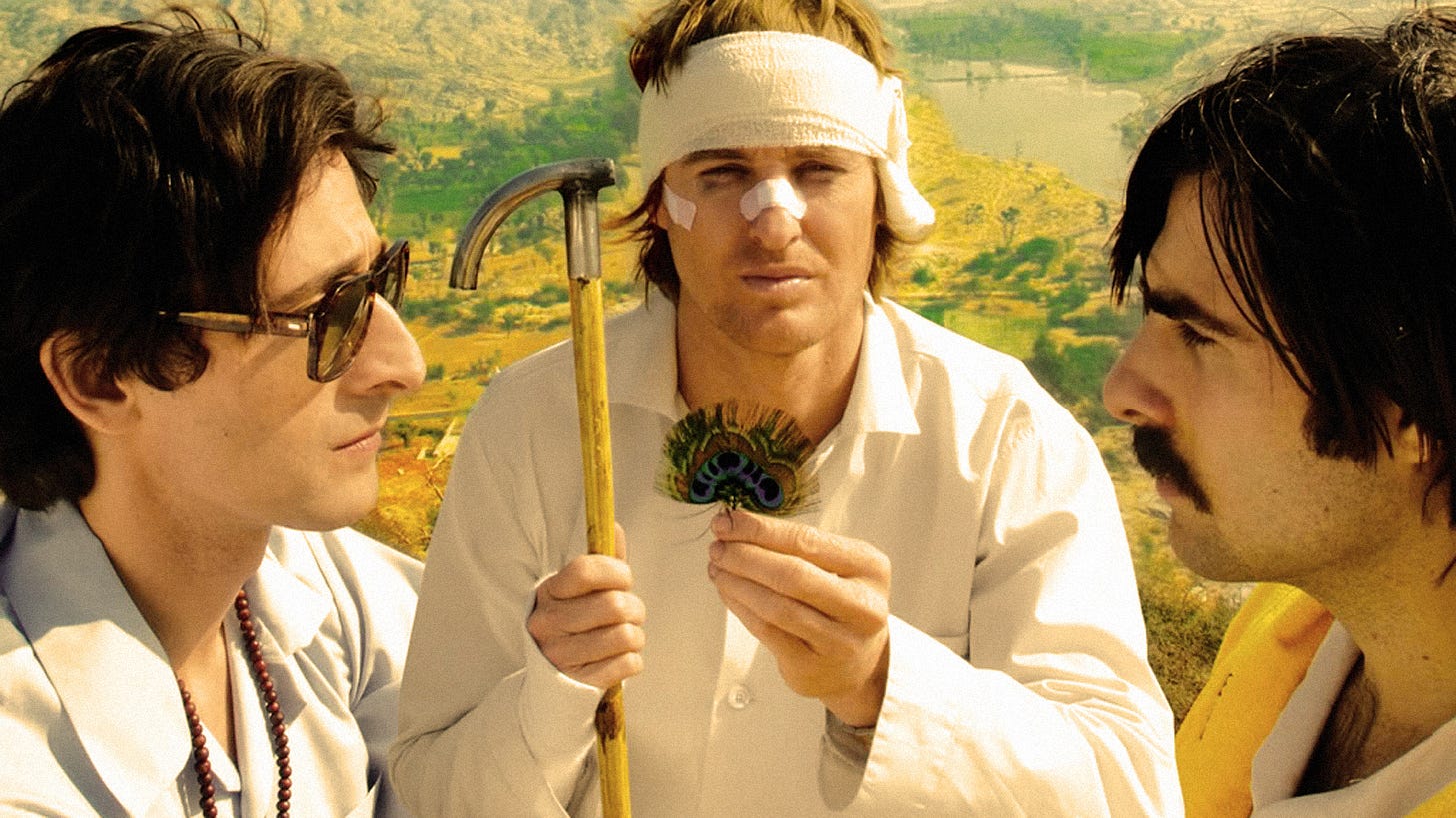 Adrien Brody, Owen Wilson, and Jason Schwartzman during the feather ritual in The Darjeeling Limited.