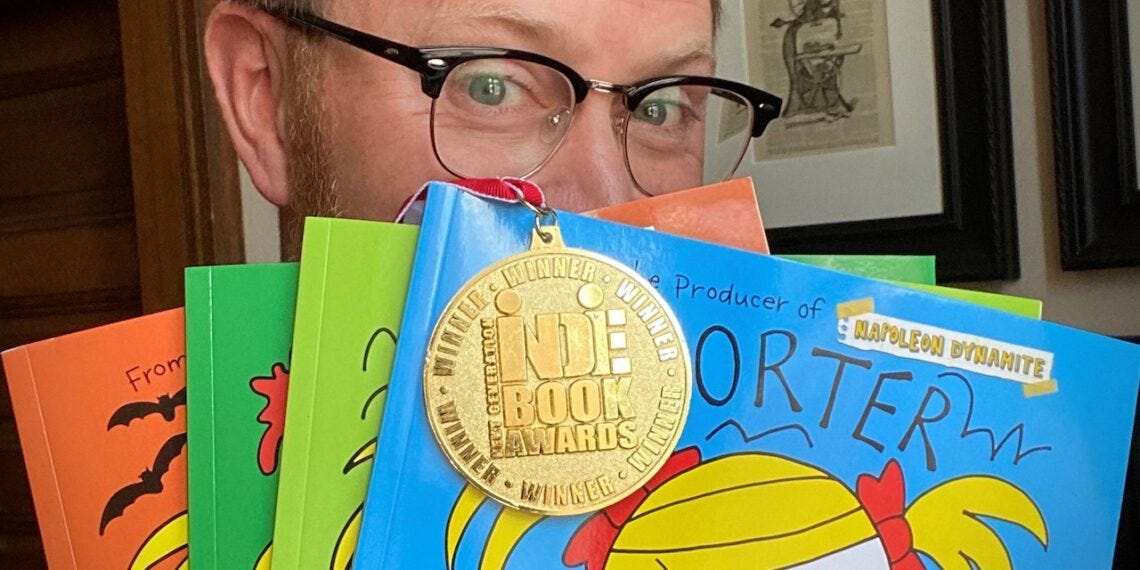 Sean Covel hides behind a selection of Porter the Hoarder books he's published. Courtesy photo.