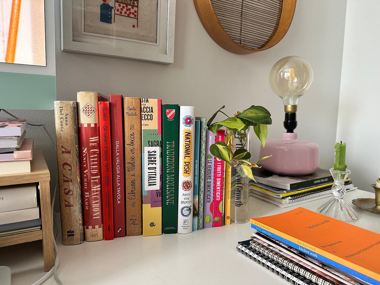 Close up photo of a row of books on a white desk. The books include Italian and English texts on Italian food, Molise, and food history. Cassandra's cookbook is in the mix.