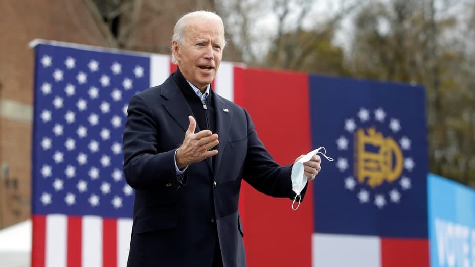 President-elect Joe Biden acknowledges the crowd as he attends a "Get Ready to Vote Rally" with Georgia's U.S. Senator Democratic nominees Reverend Raphael Warnock and Jon Ossoff on December 15, 2020 in Atlanta, Georgia.