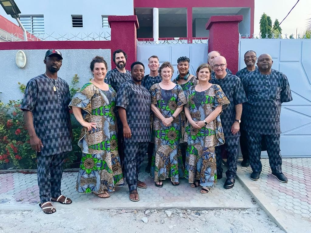 Picture of Dialogue on Race and Faith group standing in front of a house wearing matching African garb