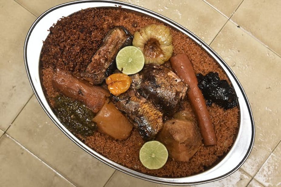 A plate of cooked rice, vegetables and fish