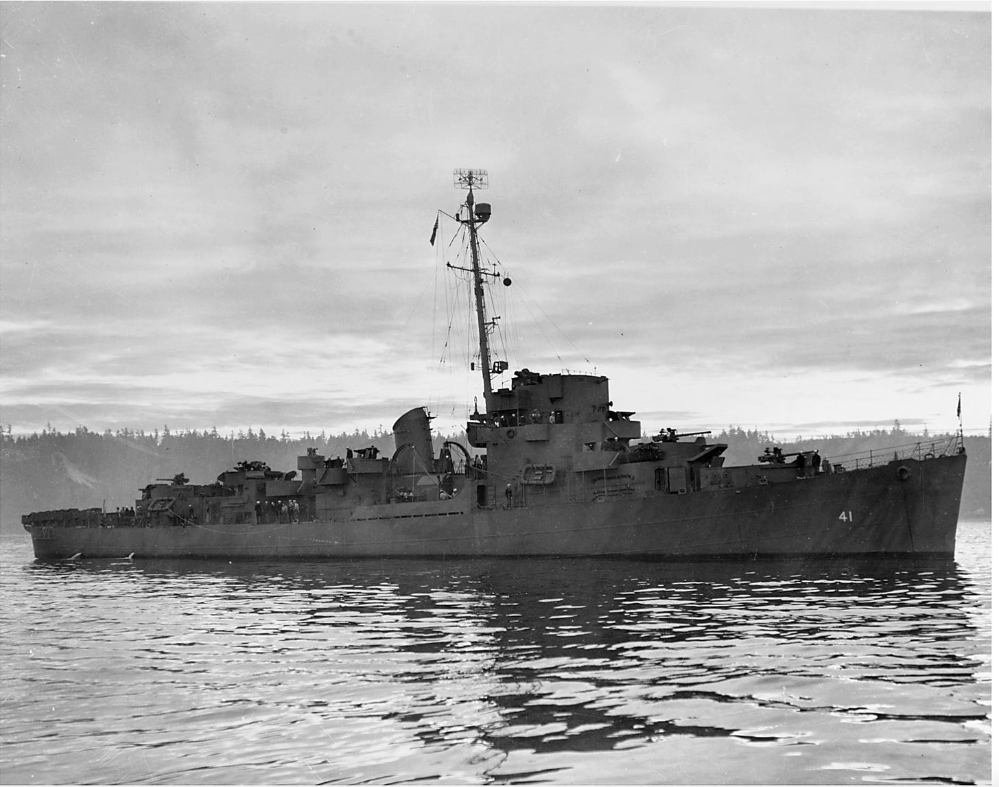 B&W photo of a WWII Naval battleship parked in Puget Sound