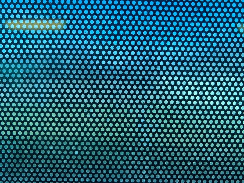 View from inside a bus looking through a perforated ad, which largely obscures the outside view