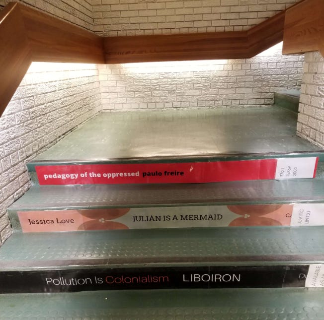 A staircase with a book on it

Description automatically generated
