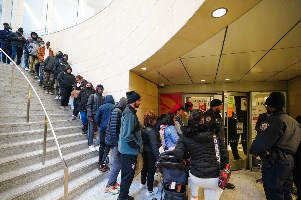 Migrants on line waiting to enter lower street level office to apply for NY ID, located at 560 Lexington Ave