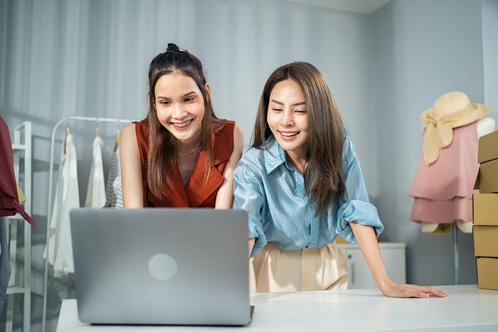 Two young women working on their online business. Two young women working on their online business.
