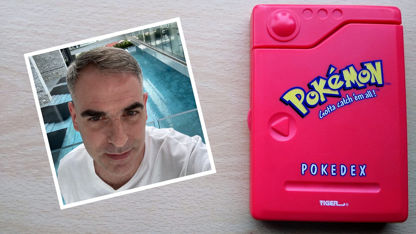 Chris Nicolella, alongside the original Pokédex toy