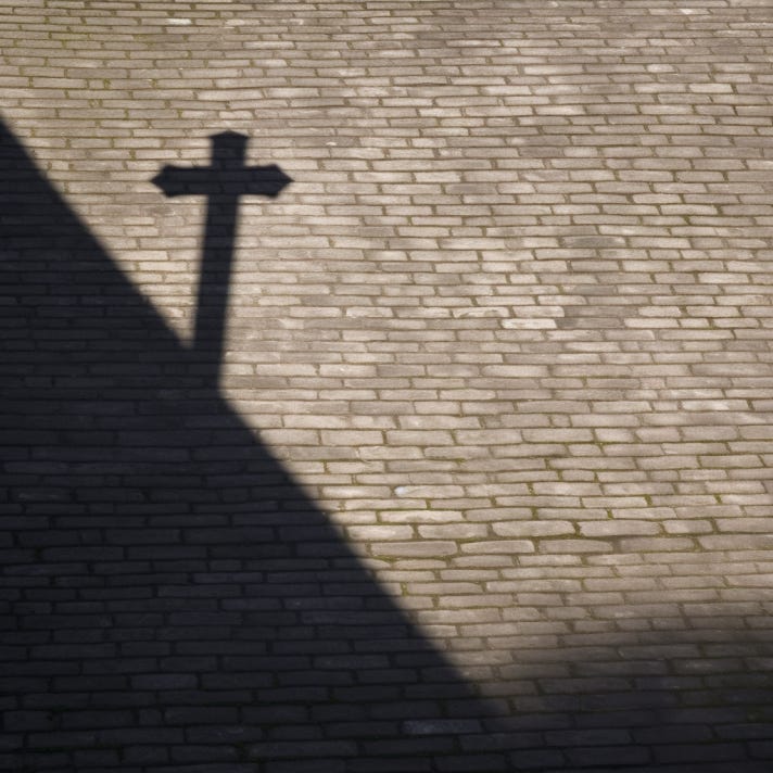 shadow of a cross on brick