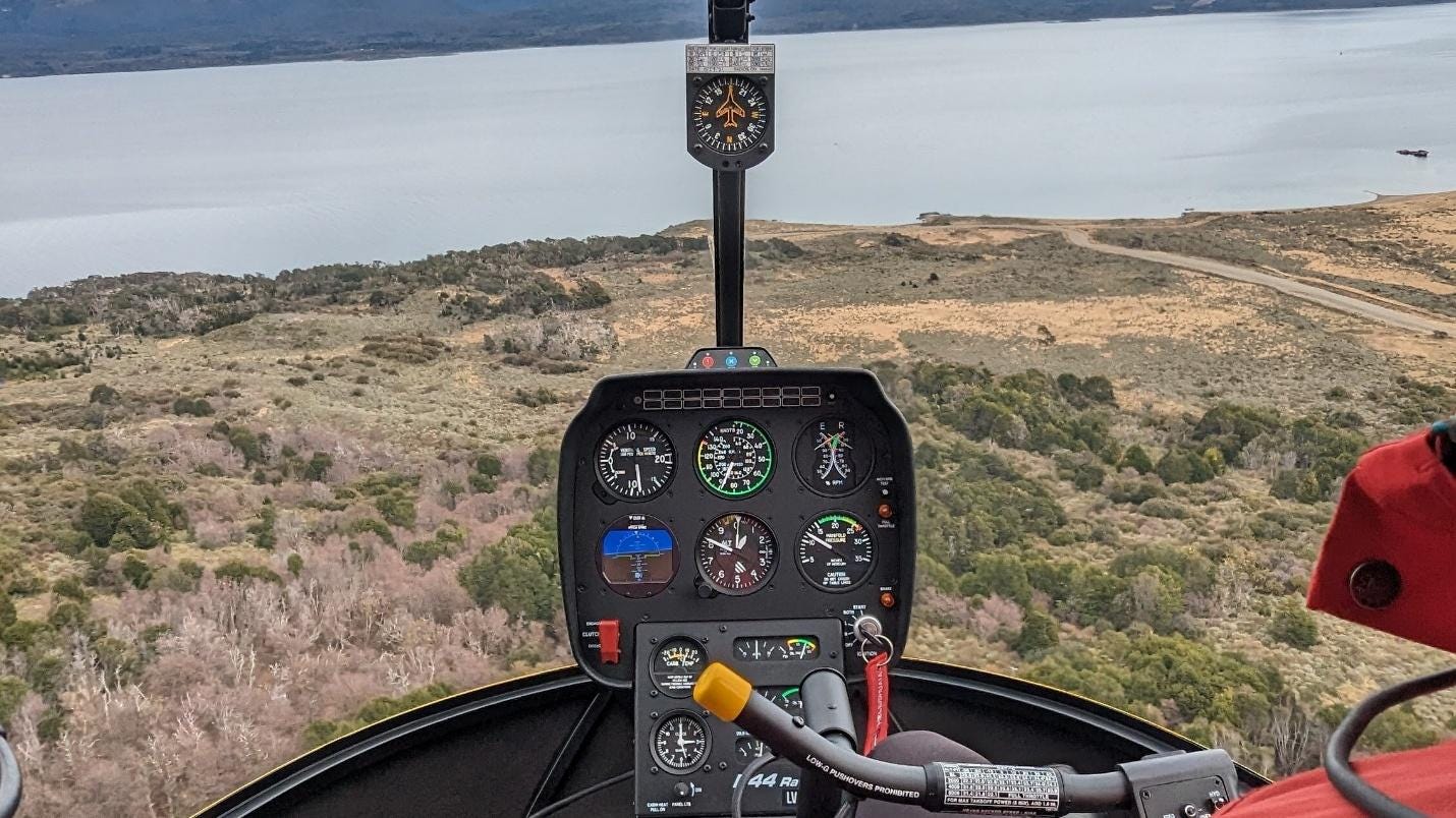 A view of a helicopter cockpit from the cockpit

Description automatically generated