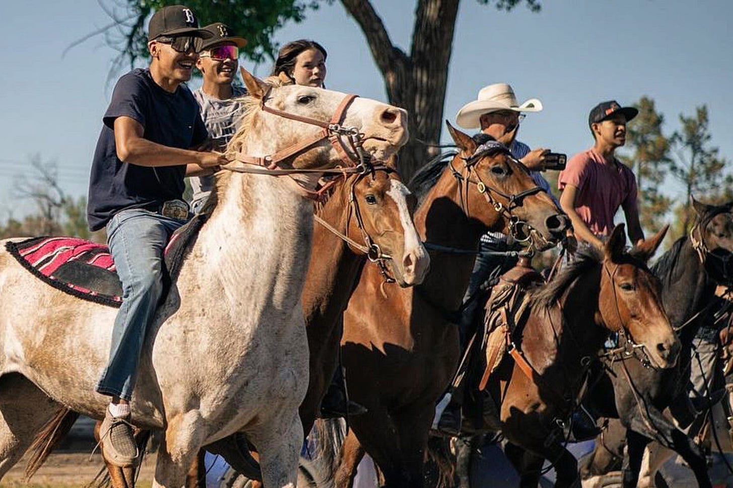 Nate Bressler with some of the Sage wranglers as they ride into the town of Pine Ridge to kick off Veterans Pow Wow on the Crazy Horse Ride.