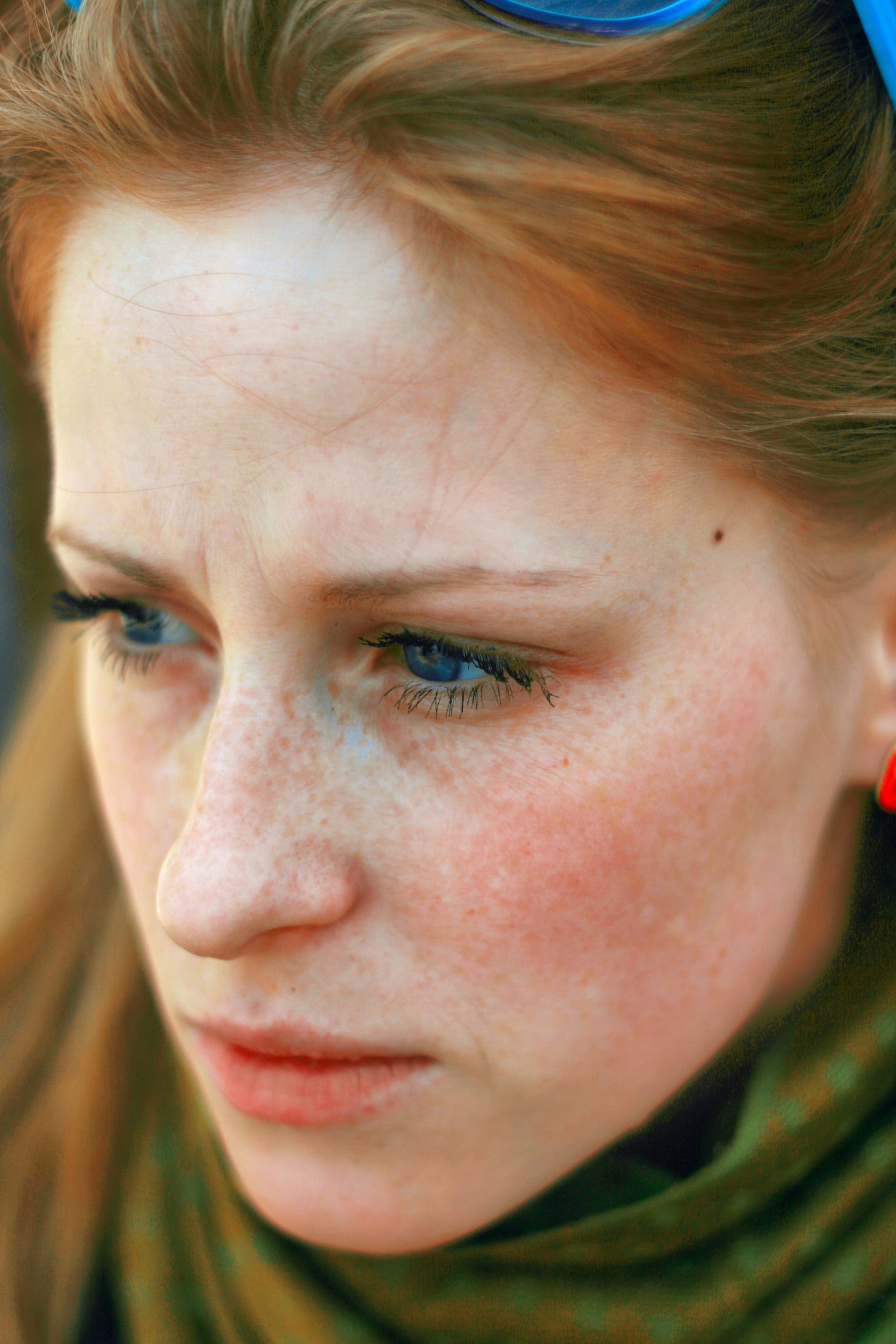 woman with red hair looking pensive and resentful