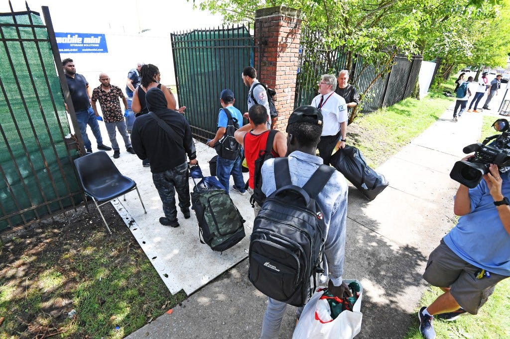 Migrants entering the new shelter at the Creedmoor Psychiatric Center in Queens on August 16, 2023.