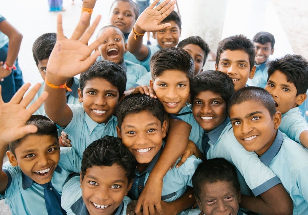 Group of rambunctious Indian children all smiling for the camera