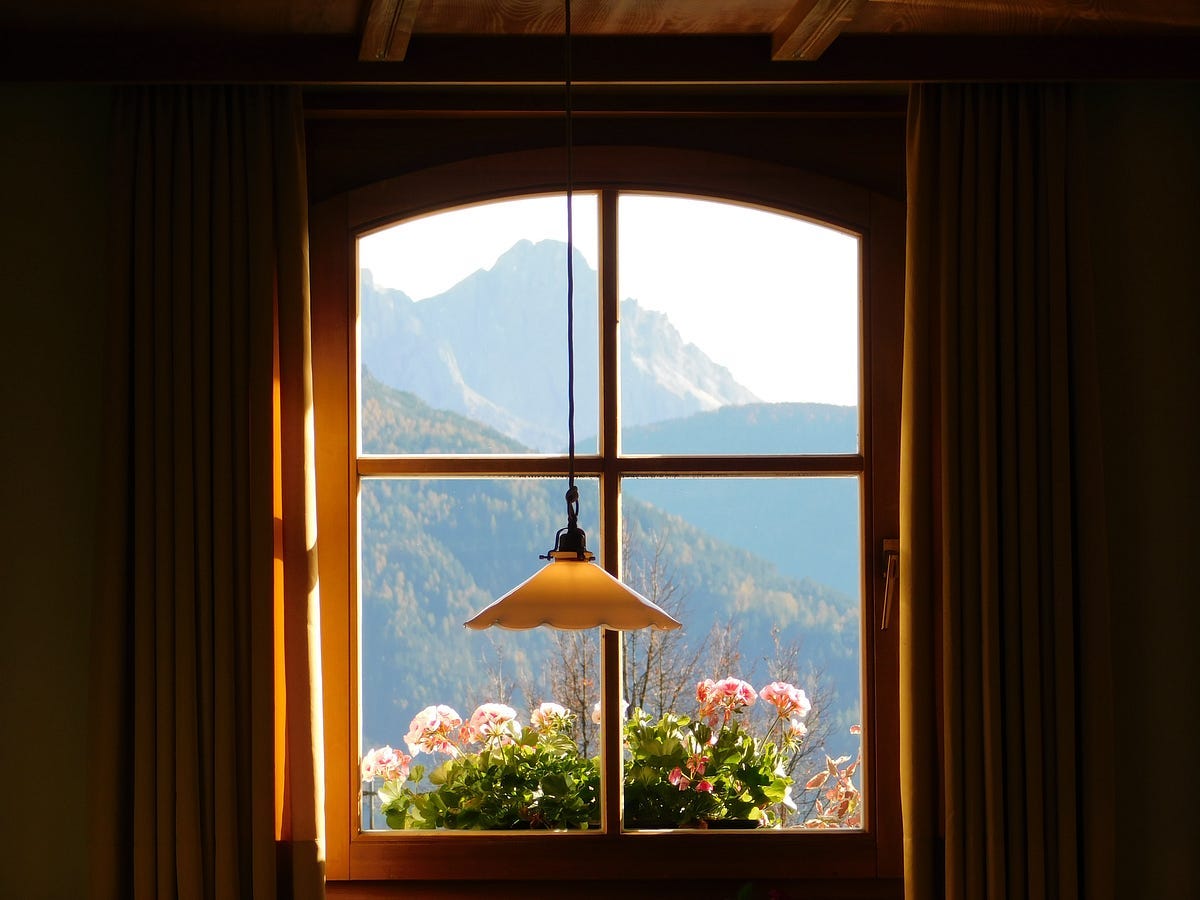 Scene through a window, hills and flowers