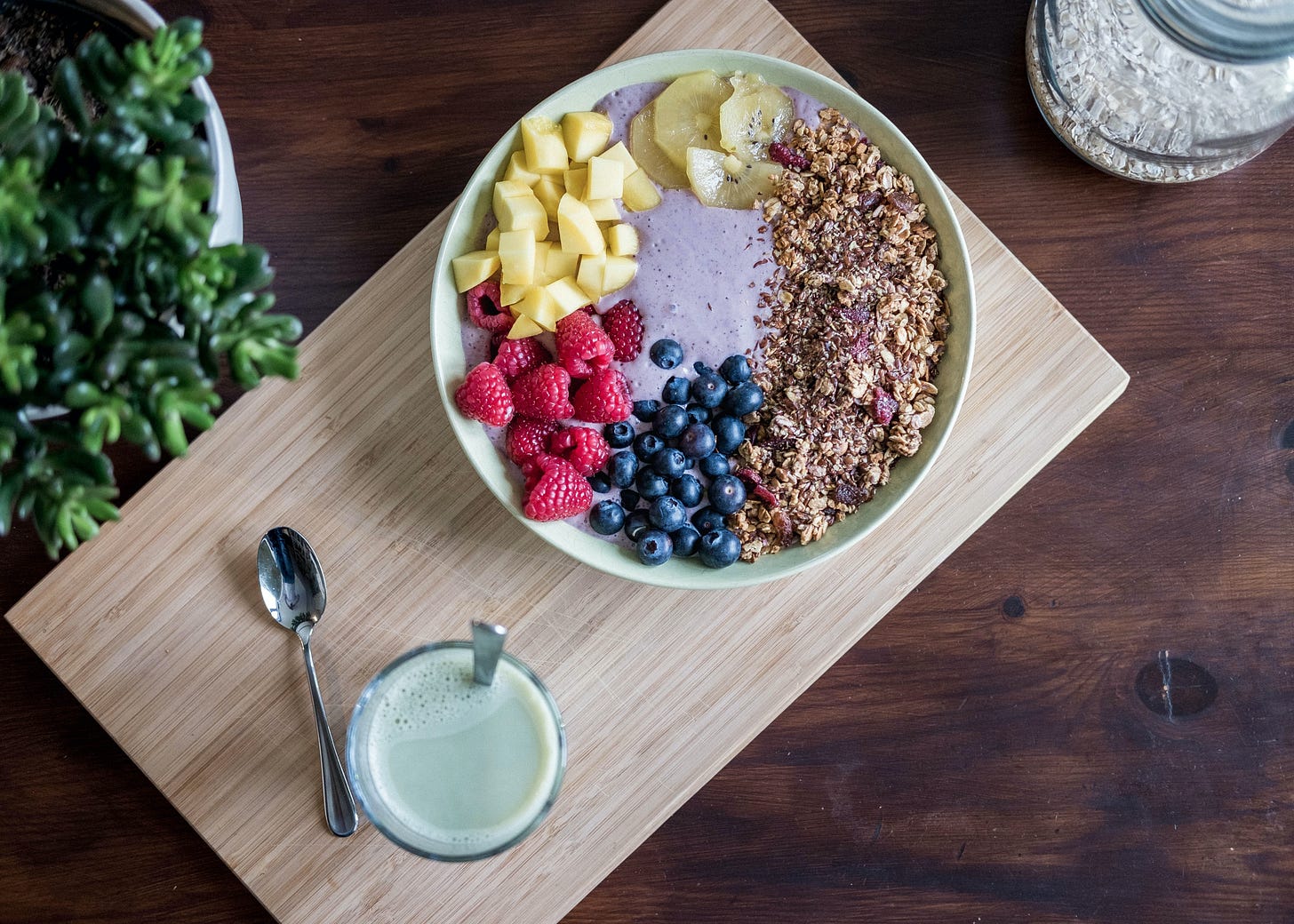 Table set with bowl of healthy grains and fruit.