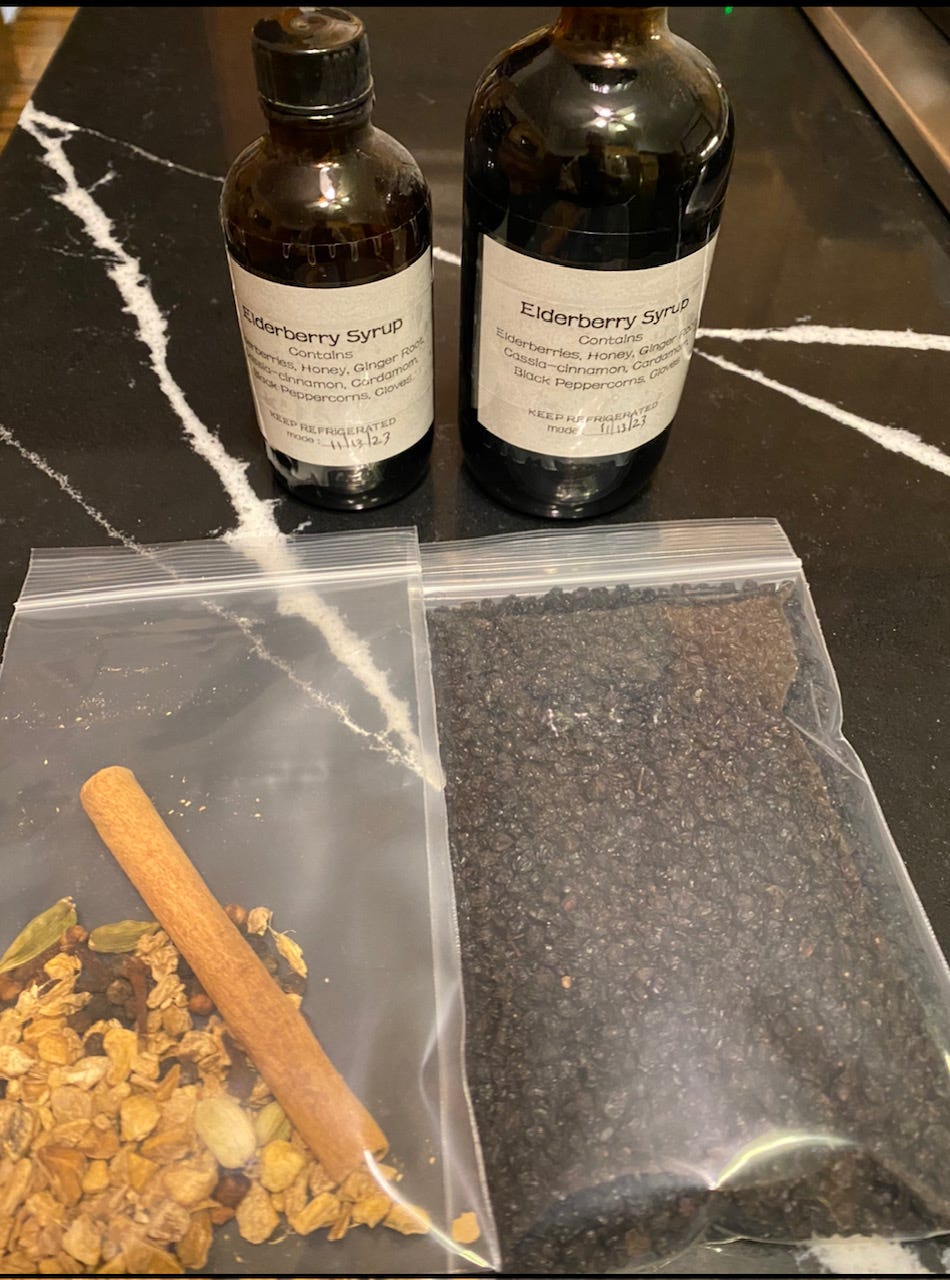 dried elderberries, spices, and finished elderberry syrup in bottles