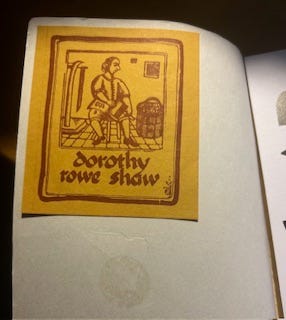 On the inside flap of a book is a yellow square with a red drawing of a man and text reading Dorothy Rowe Shaw