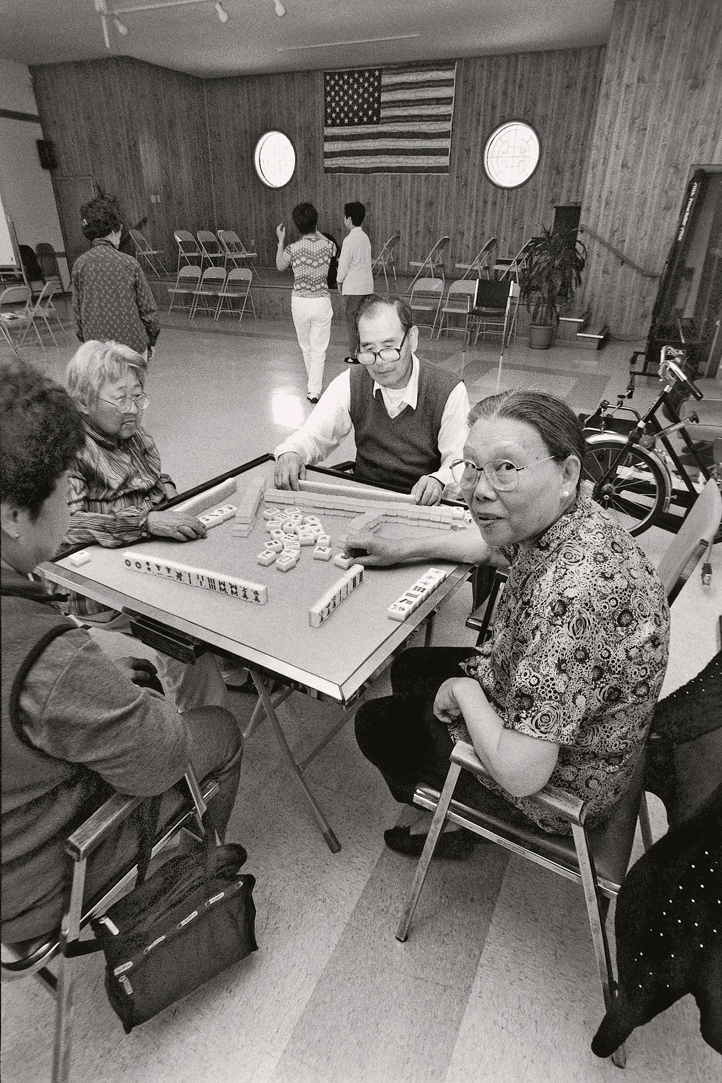 Elderly Asian people playing a table game.