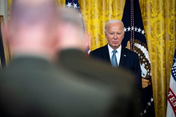 President Biden gazes downward during a ceremony at the White House. 