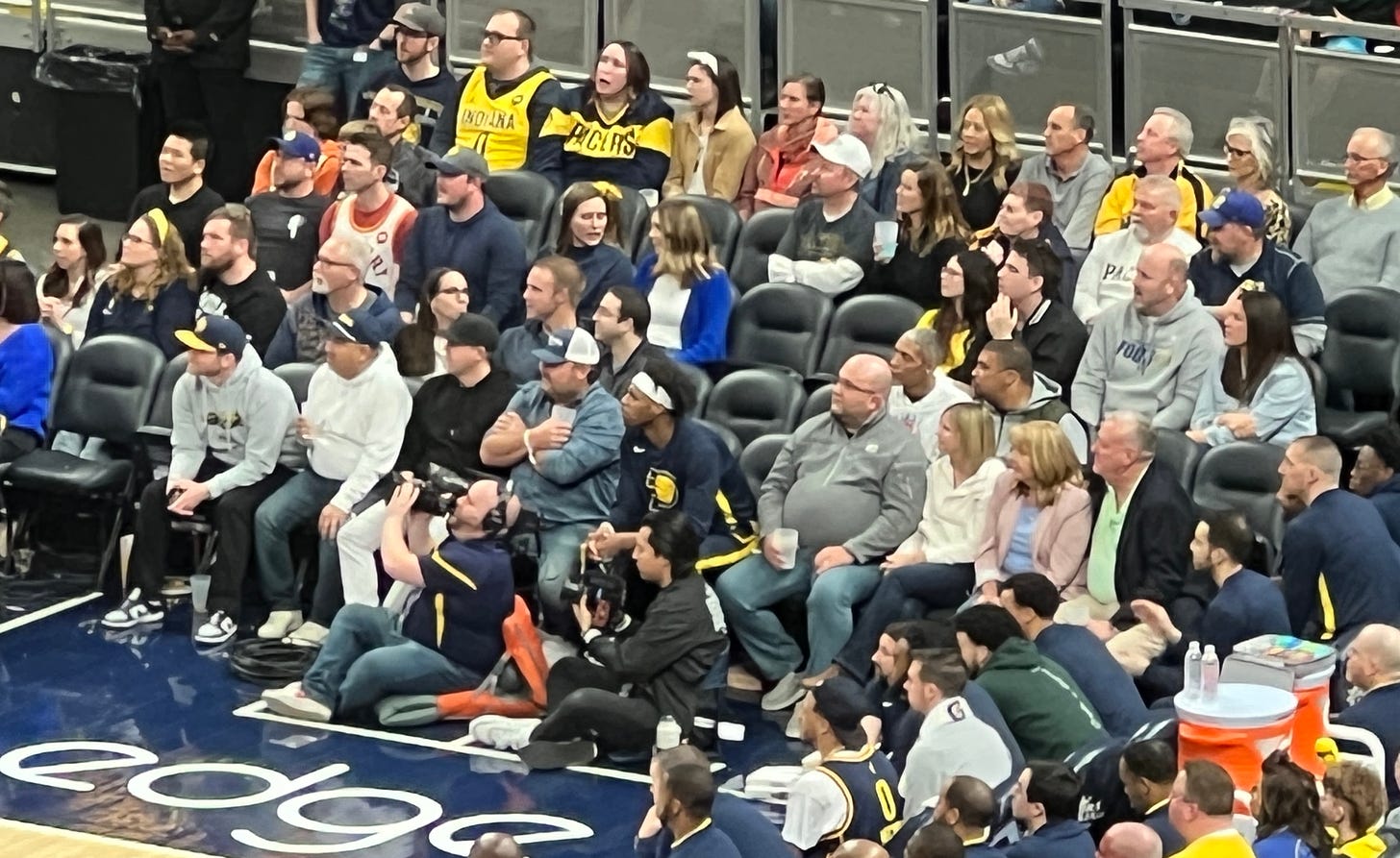 Pacers guard Buddy Hield sits amongst fans.