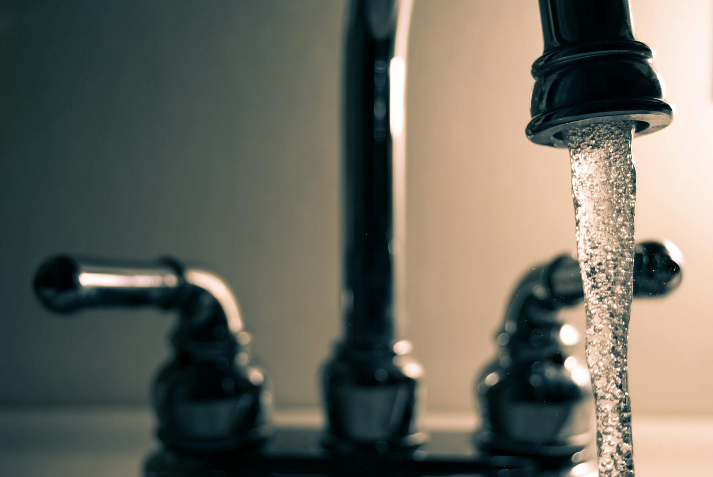 Water faucet with water running. Water faucet with water running.