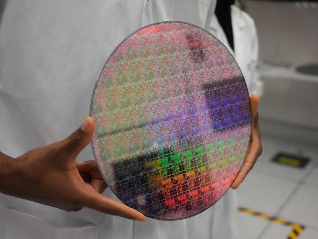 A technician holds a silicon wafer. Industry experts say super-pure quartz is essential in the production of wafers, and Spruce Pine, N.C., is America’s sole source.