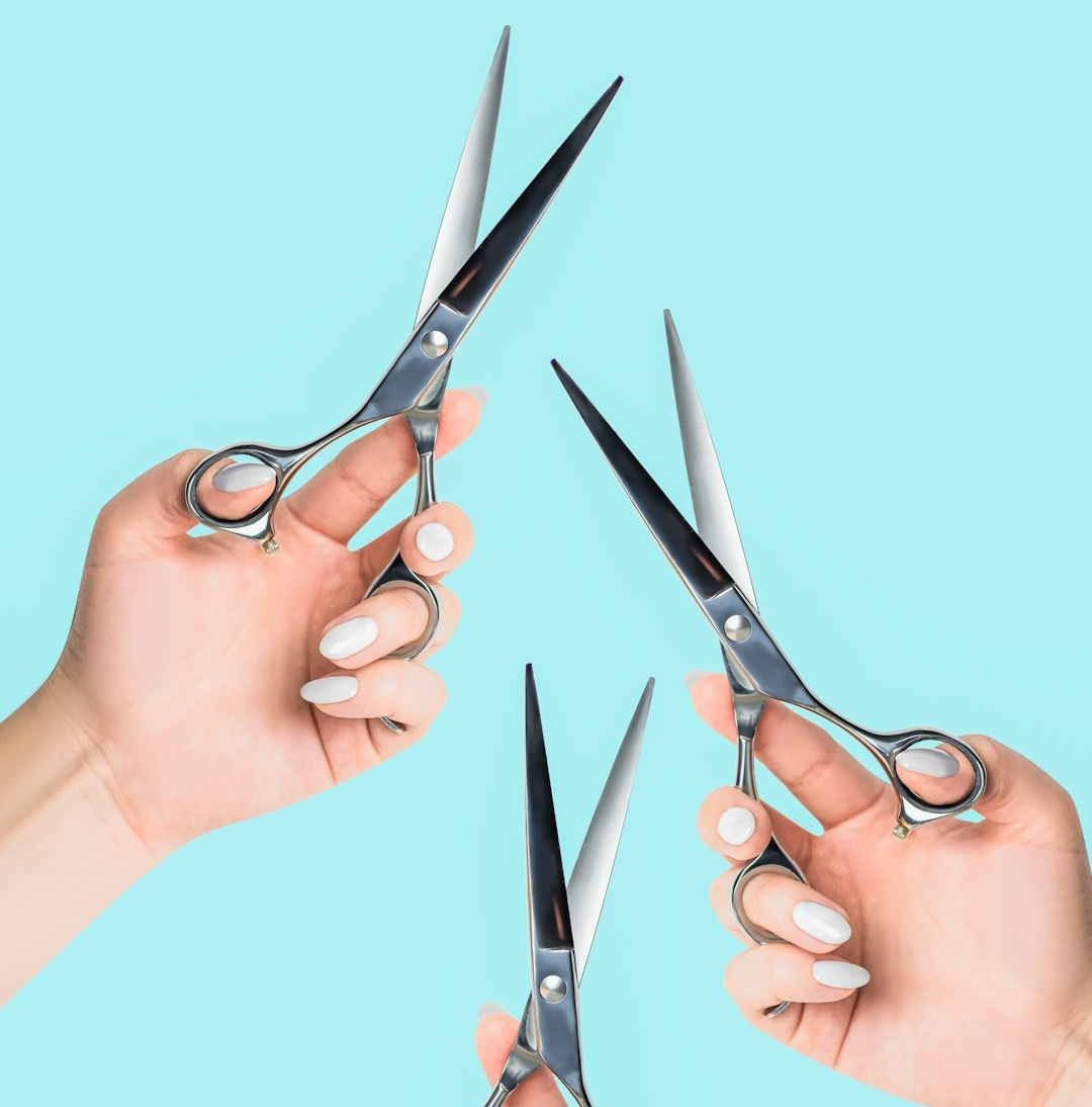 a pair of hands holding a pair of scissors