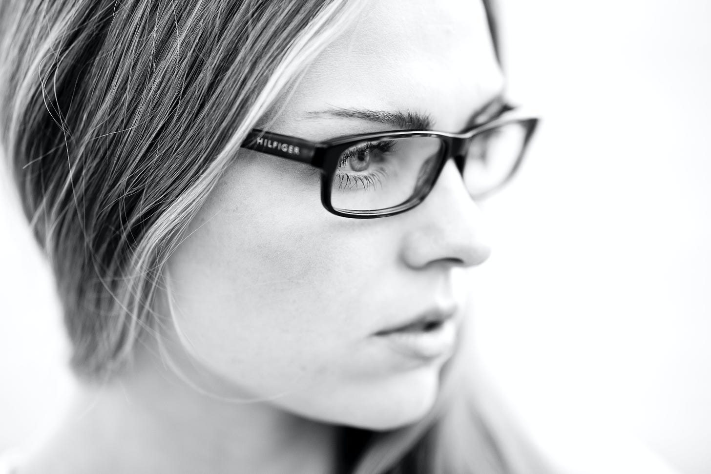 Black and white of woman with glasses and brunette hair