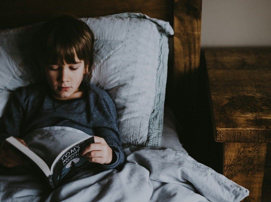 boy reading Tom's book on bed boy reading Tom's book on bed