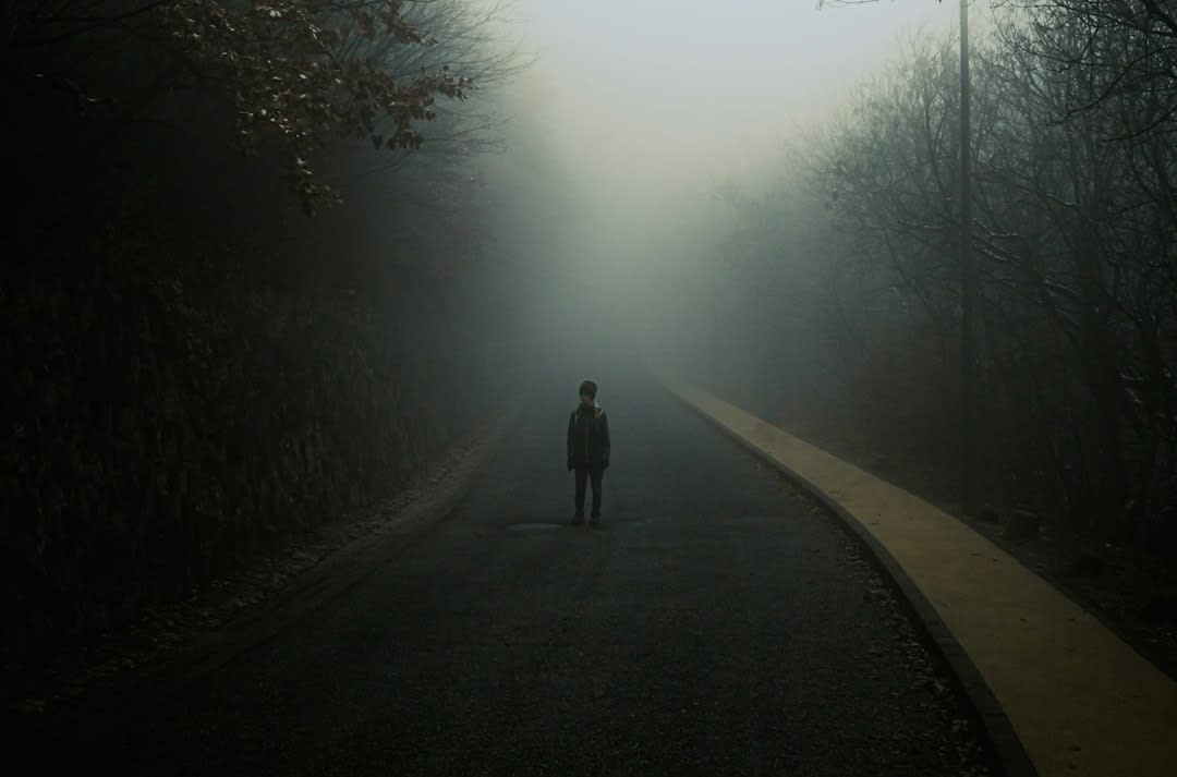 a person standing in the middle of a road