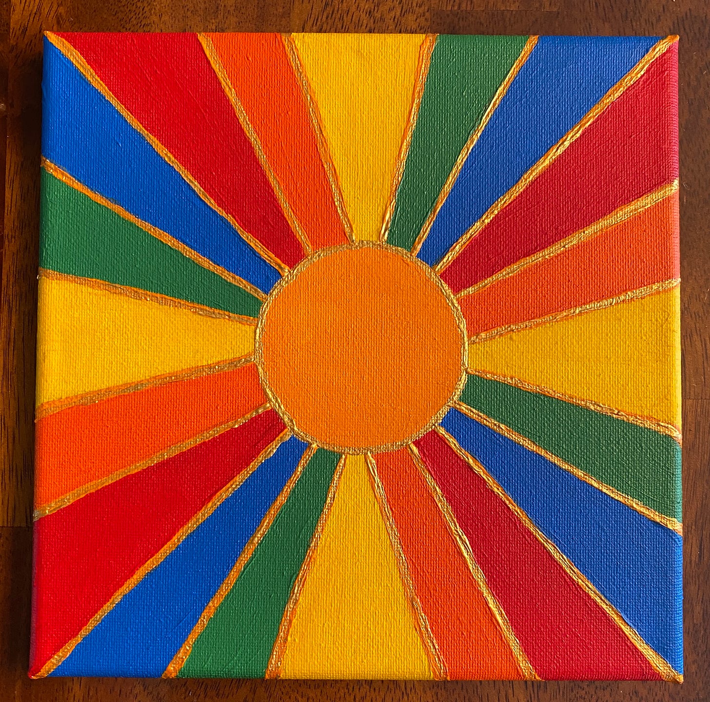 A rainbow sunshine painting with gold outlines