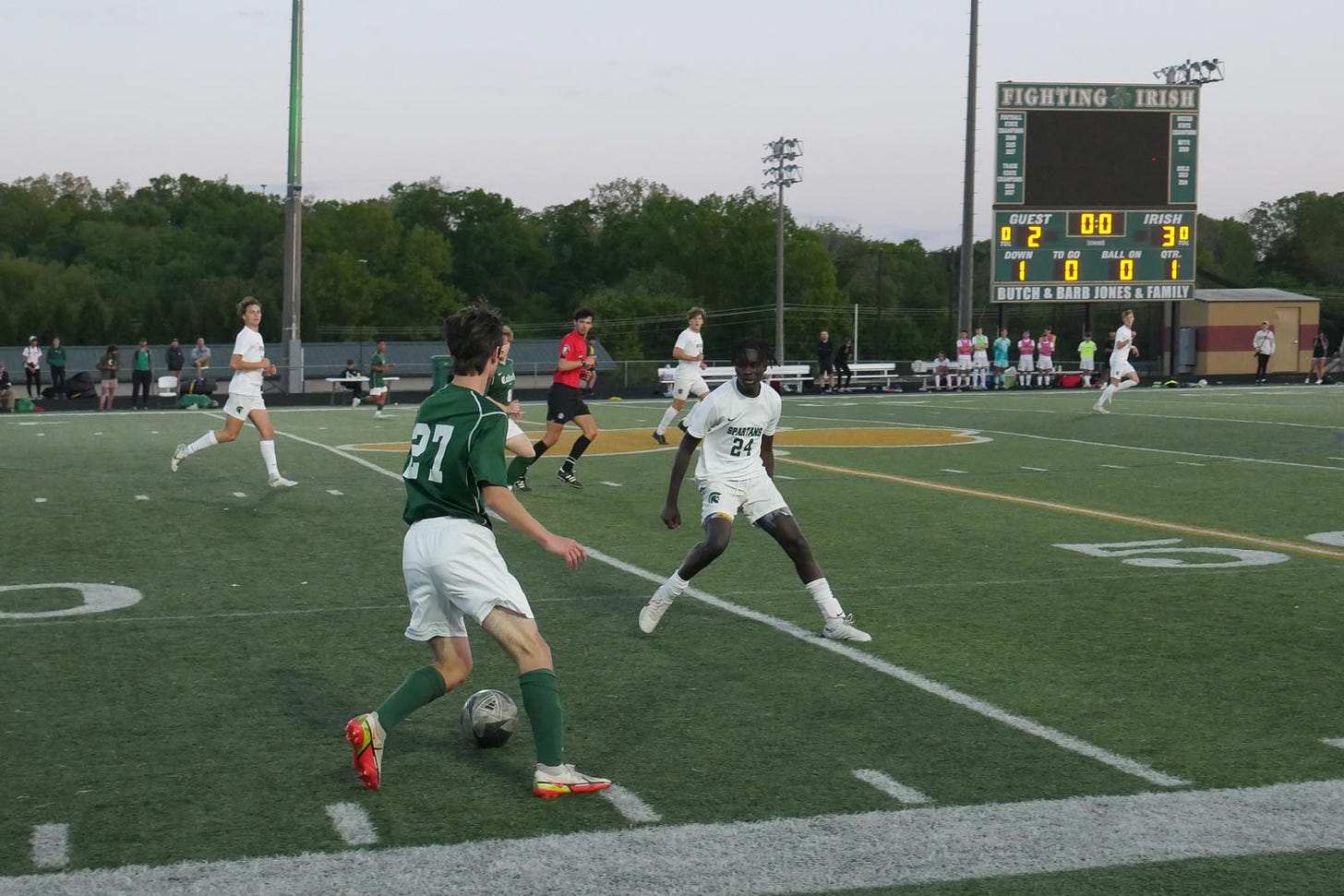 Knoxville Catholic and Webb boys soccer players compete on the field.