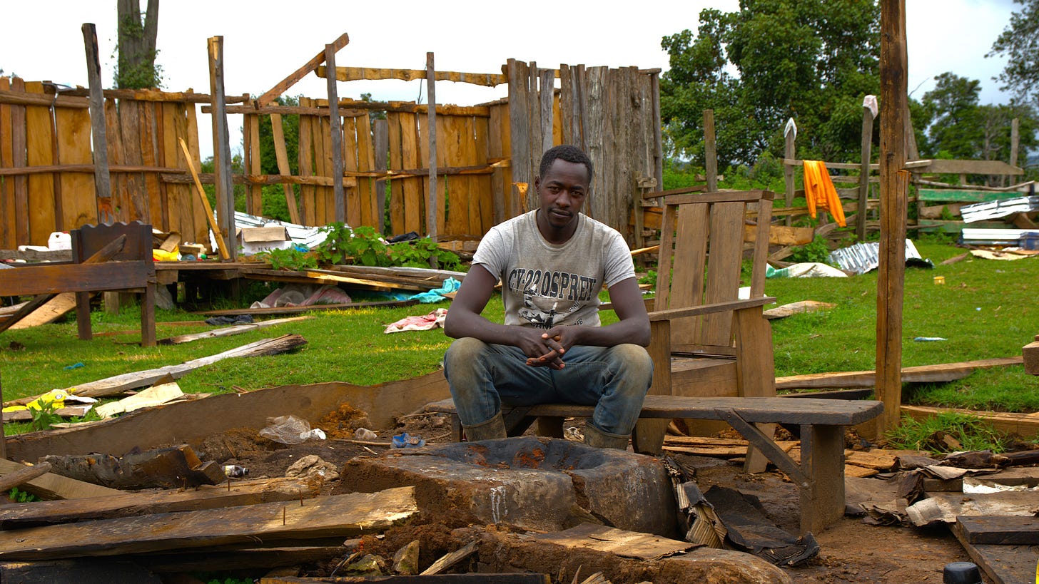 Peter Nagul sit on the rubble that used to be his house.