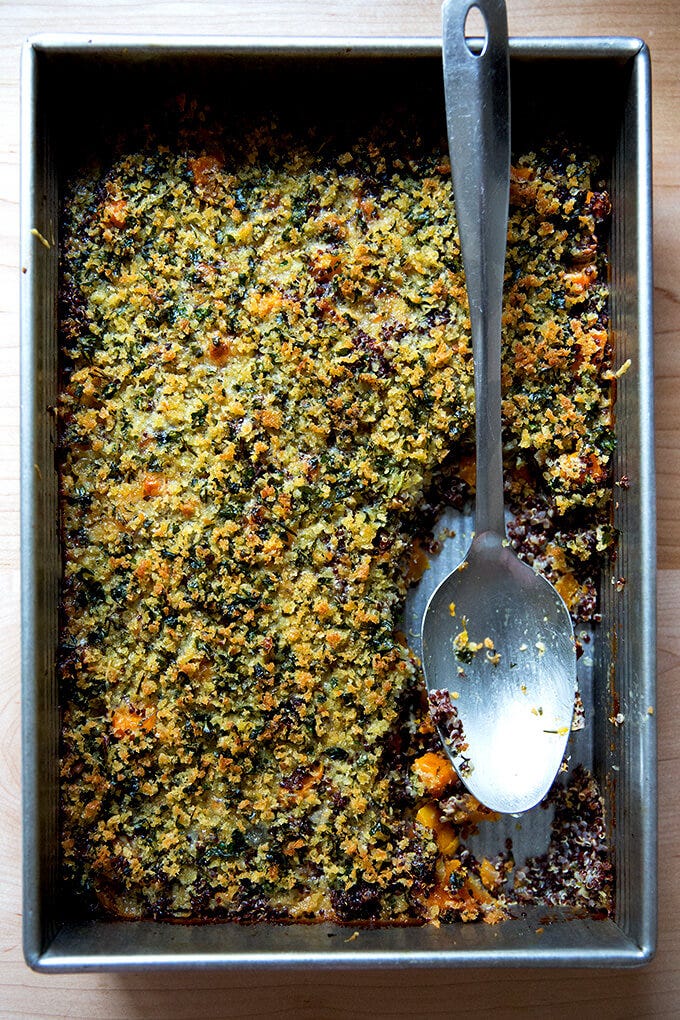 A 9x13-inch pan of just-baked quinoa bake with roasted butternut squash and onions.