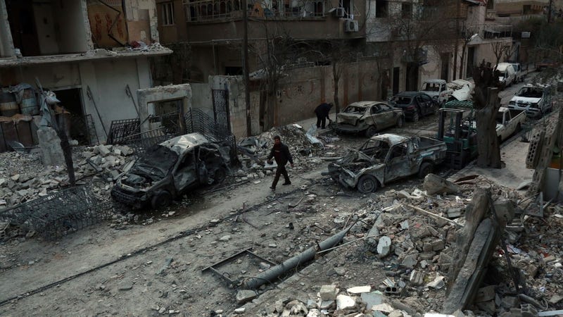 A man walks next to damaged buildings following air strikes today in the rebel-held town of Douma, Eastern Ghouta