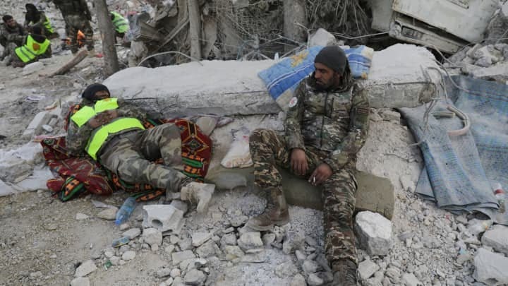 Members of Turkey-backed Syrian National Army rest in the aftermath of an earthquake, in rebel-held town of Jandaris, Syria February 11, 2023. 