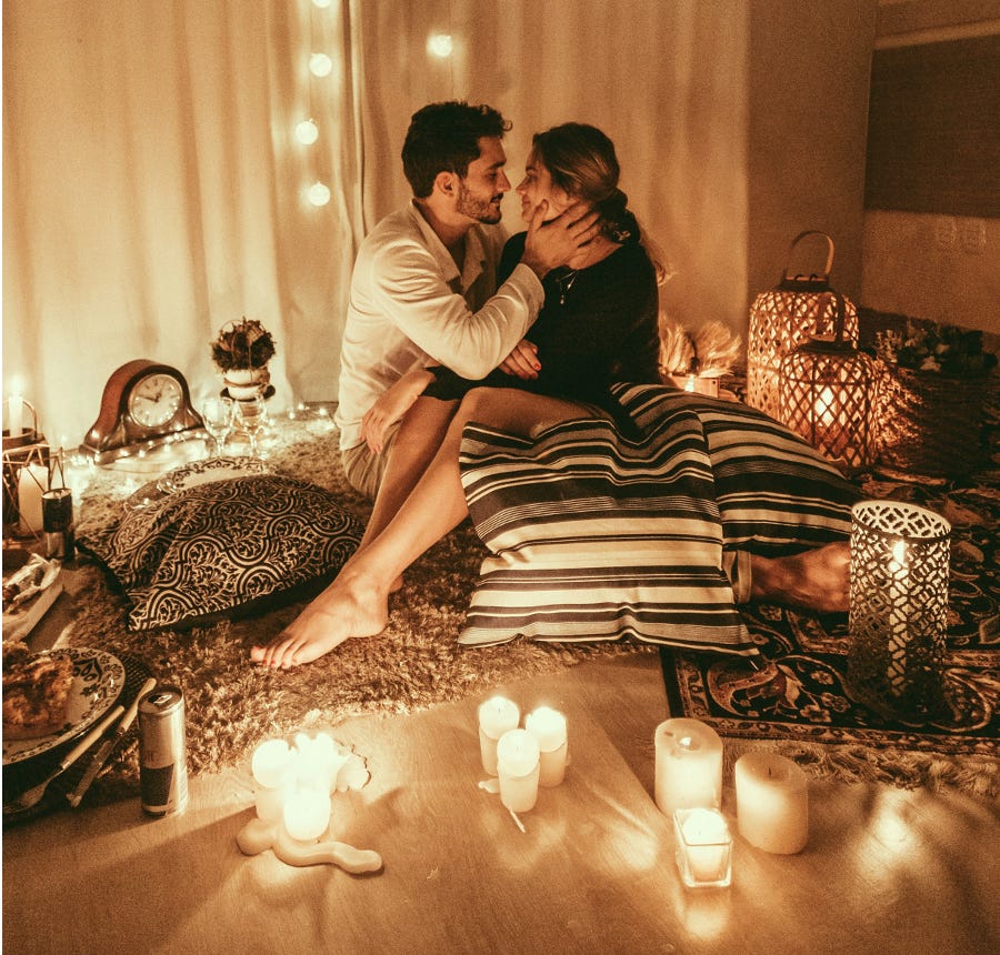 Man and woman in candlelit setting
