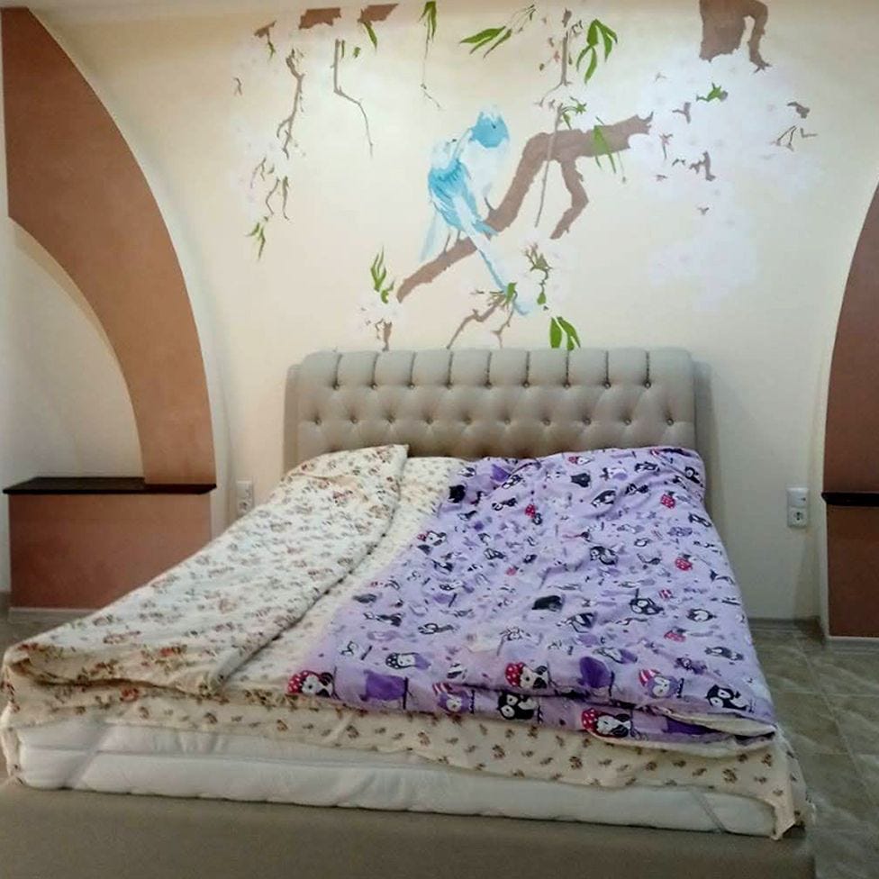 Marina’s bedroom with cherry blossom and doves pictured on the wall