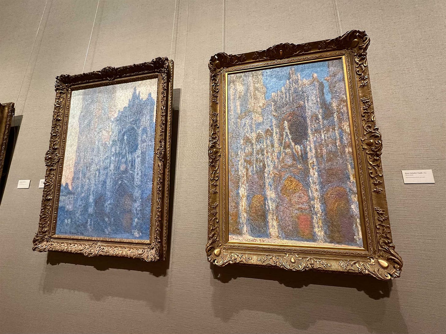 Two paintings, displayed side by side, of the facade of the Rouen Cathedral shown under different light conditions by the artist.