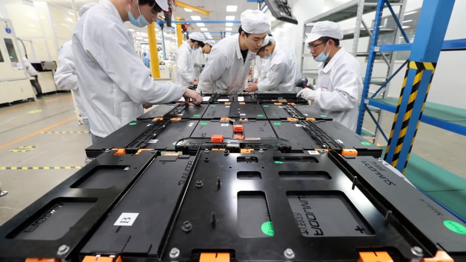 This photo taken on March 12, 2021 shows workers at a factory for Xinwangda Electric Vehicle Battery Co. Ltd, which makes lithium batteries for electric cars and other uses, in Nanjing in China's eastern Jiangsu province.