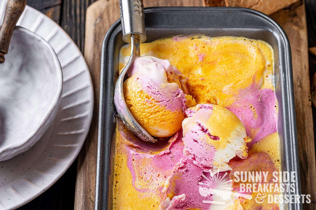 Scooping rainbow sherbet ice cream.