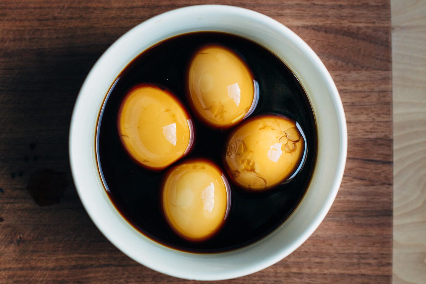 Four eggs marinating in soy sauce
