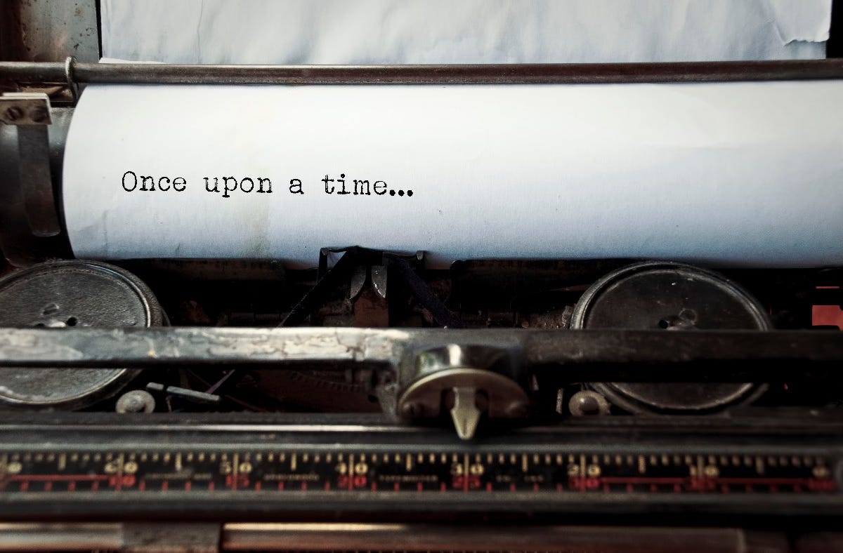 close up image of typewriter with paper sheet and the phrase: once upon a time.