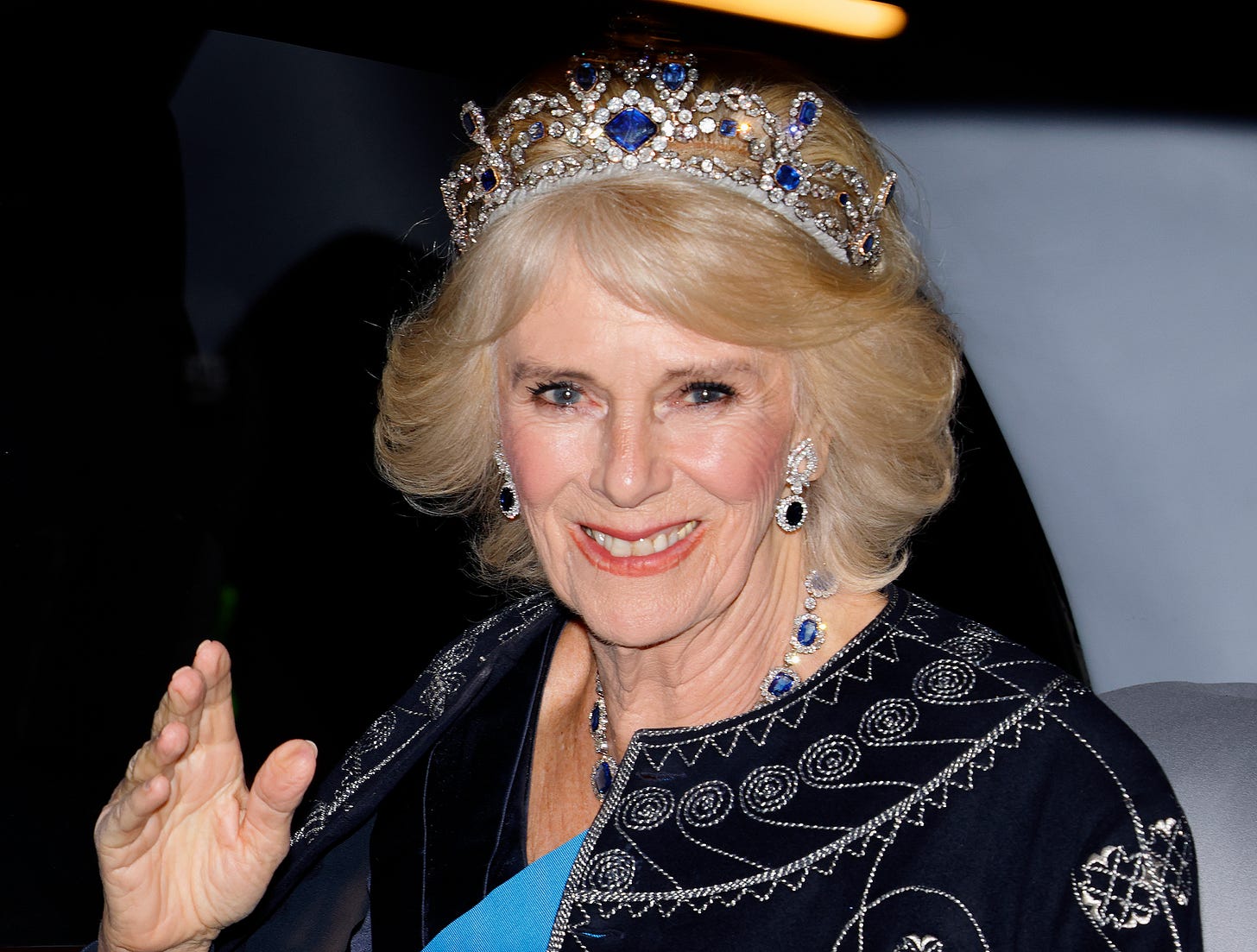 Queen Camilla waving wearing crown