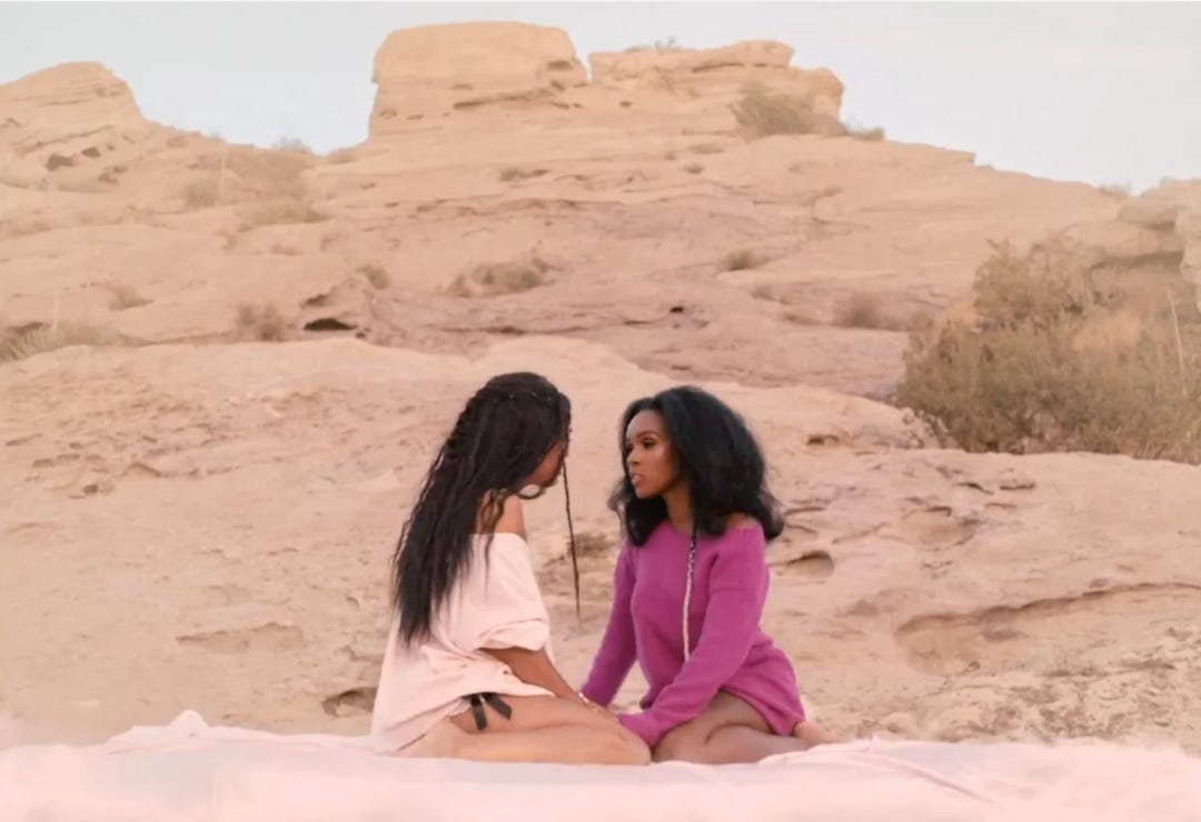 Janelle Monae romantically holds hands with her girlfriend, Tessa Thompson while sitting in the desert