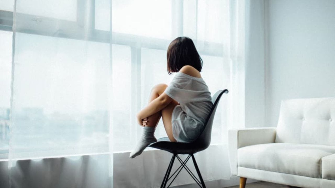 Woman in chair by window - image by Anthony Tran on unsplash